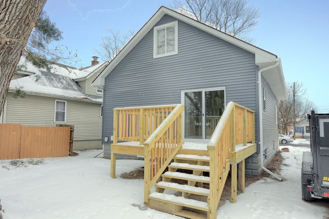 view of snow covered back of property