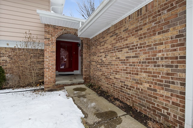 view of snow covered property entrance