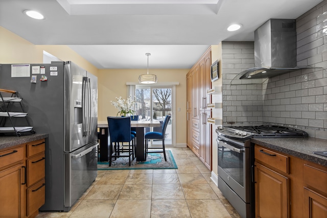 kitchen featuring stainless steel appliances, decorative light fixtures, light tile patterned flooring, tasteful backsplash, and wall chimney range hood