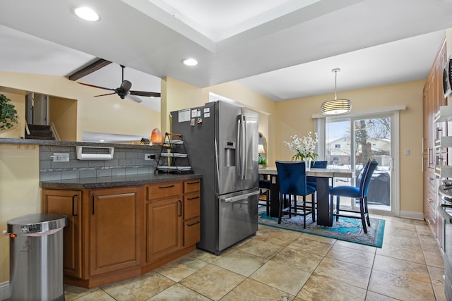 kitchen featuring ceiling fan, stainless steel fridge, lofted ceiling with beams, and hanging light fixtures