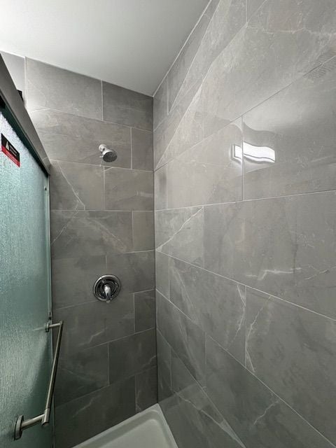 bathroom with tiled shower