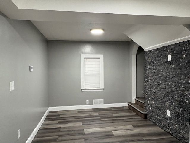 basement featuring dark hardwood / wood-style floors