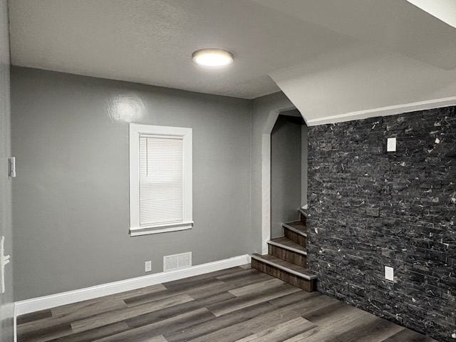 staircase with hardwood / wood-style flooring