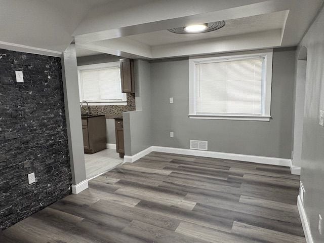 unfurnished dining area with sink and hardwood / wood-style flooring