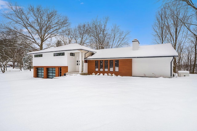 view of snow covered back of property