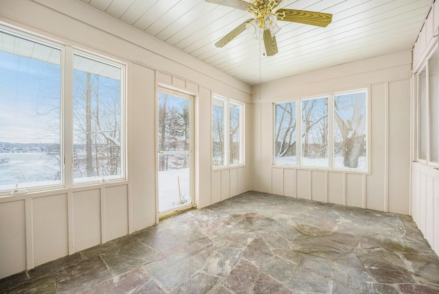 unfurnished sunroom featuring ceiling fan