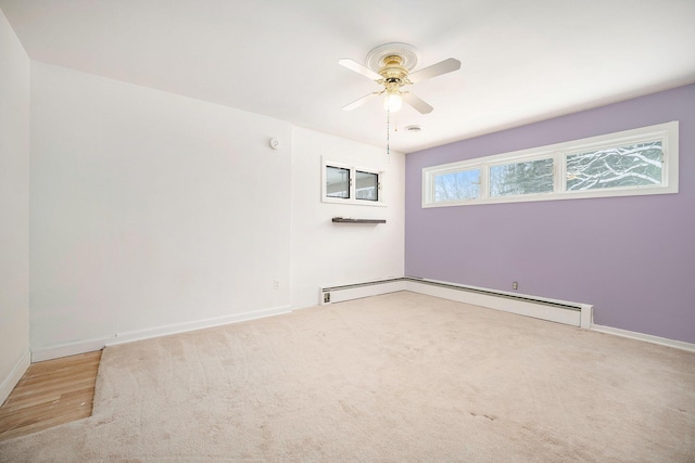 carpeted empty room featuring ceiling fan and a baseboard radiator