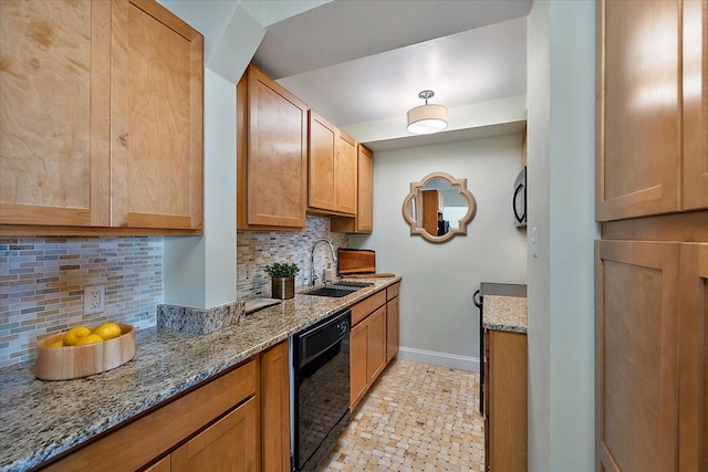 kitchen featuring black appliances, decorative backsplash, light stone countertops, and sink