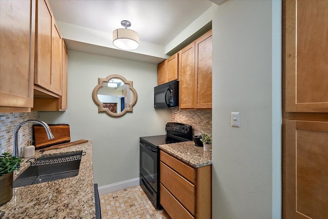 kitchen with sink, backsplash, light stone counters, and black appliances