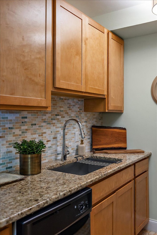 kitchen with decorative backsplash, sink, light stone counters, and dishwasher