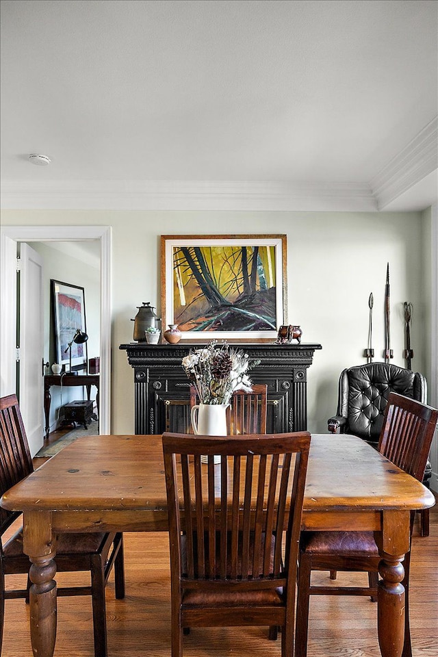 dining space featuring crown molding and hardwood / wood-style floors