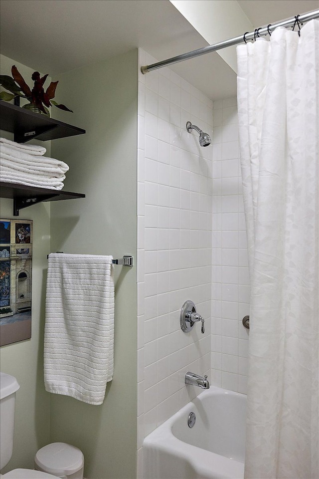 bathroom featuring toilet and shower / bathtub combination with curtain