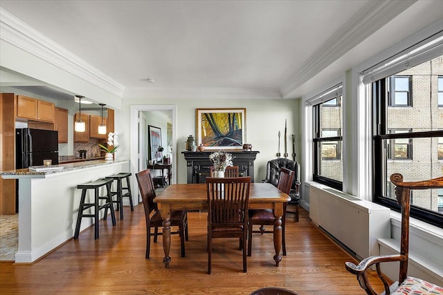 dining room with dark hardwood / wood-style flooring and ornamental molding