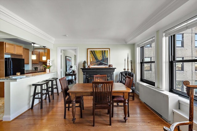 dining room featuring crown molding and hardwood / wood-style floors