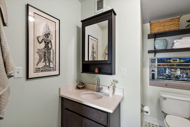 bathroom featuring toilet and vanity