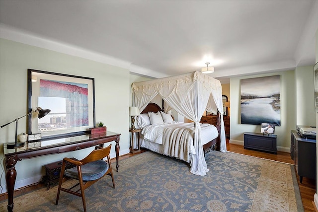 bedroom with dark hardwood / wood-style floors