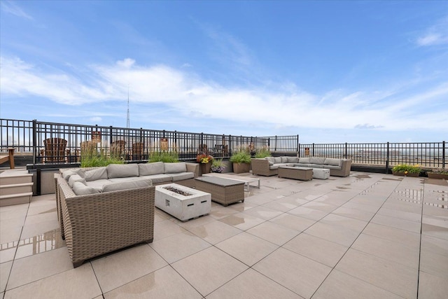 view of patio / terrace with an outdoor living space with a fire pit