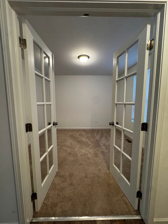 hall with french doors and carpet flooring