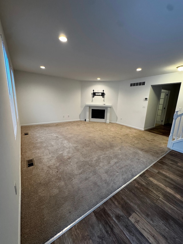 unfurnished living room featuring dark wood-type flooring