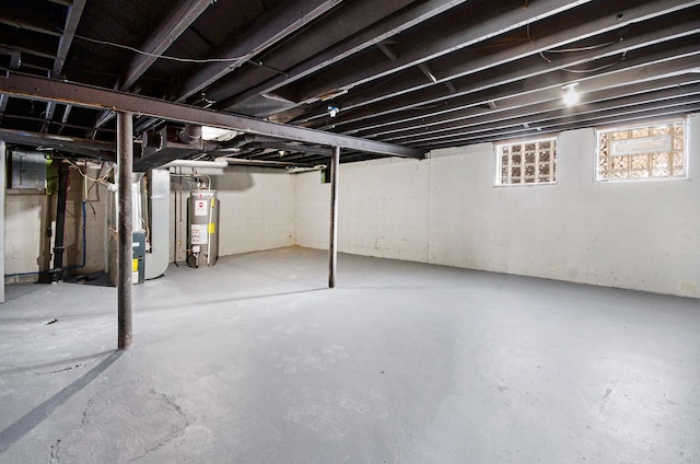 basement featuring water heater and heating unit