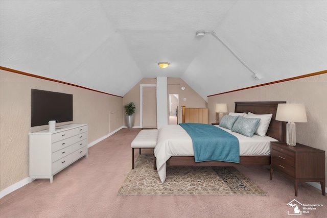 bedroom featuring light colored carpet, vaulted ceiling, and a textured ceiling