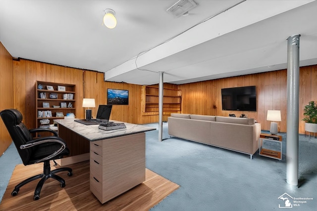 carpeted office with wood walls