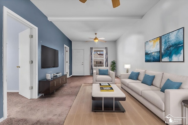 carpeted living room featuring ceiling fan and vaulted ceiling with beams