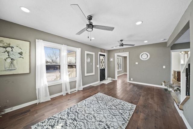 living room with ceiling fan and dark hardwood / wood-style floors