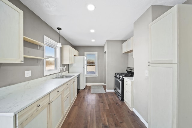 kitchen with sink, white refrigerator, decorative light fixtures, black dishwasher, and gas range