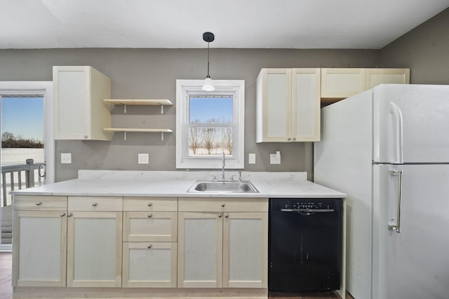 kitchen with white refrigerator, sink, dishwasher, cream cabinets, and pendant lighting