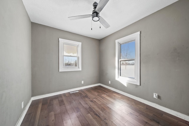 unfurnished room featuring a textured ceiling, ceiling fan, and dark hardwood / wood-style floors