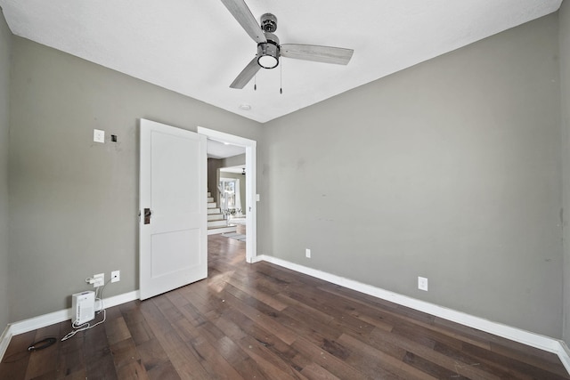 unfurnished room with ceiling fan and dark hardwood / wood-style floors