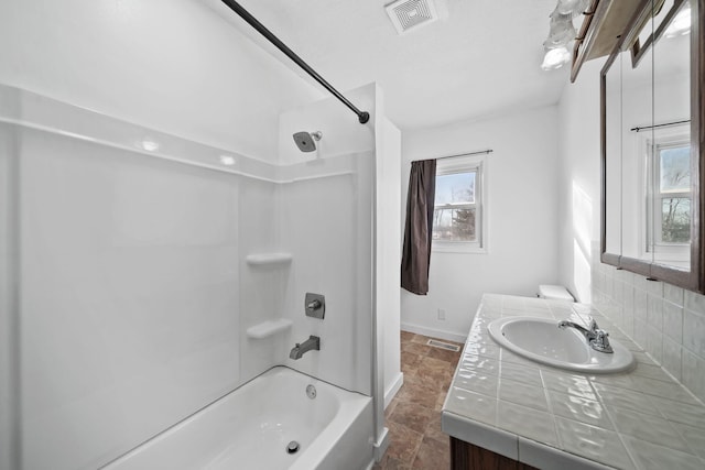 bathroom featuring tub / shower combination, tasteful backsplash, and vanity