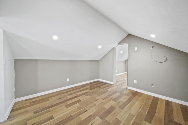 bonus room featuring lofted ceiling and light hardwood / wood-style floors