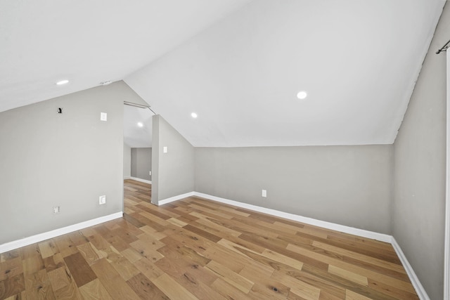 bonus room with lofted ceiling and light hardwood / wood-style flooring