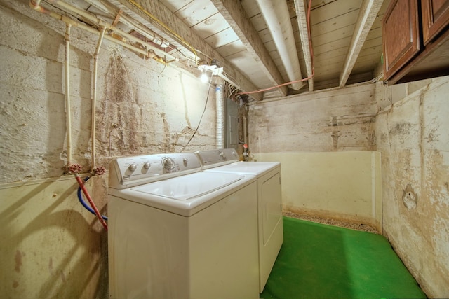 washroom with separate washer and dryer and cabinets