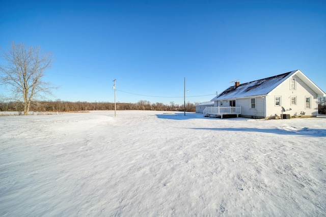 snowy yard featuring a wooden deck