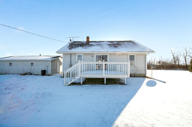 snow covered property with a wooden deck