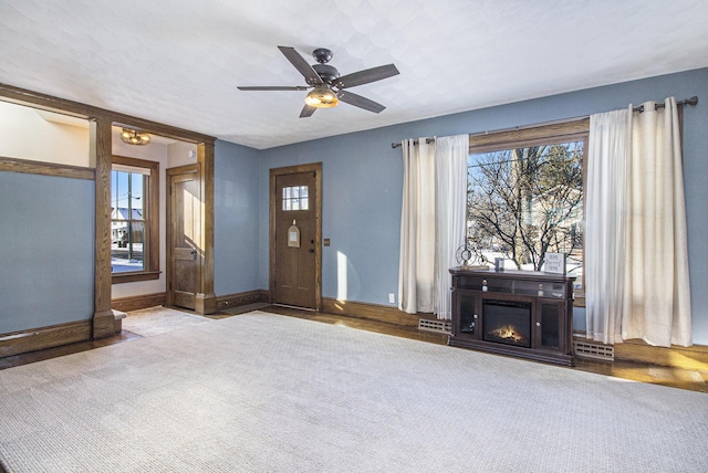 unfurnished living room with ceiling fan and light colored carpet