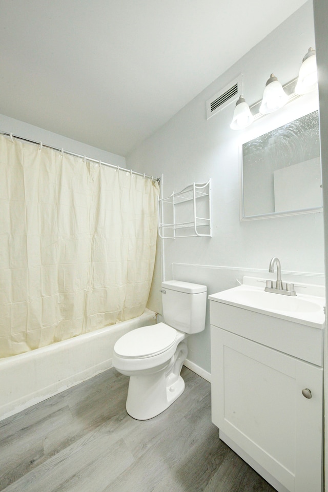 full bathroom featuring toilet, vanity, shower / bath combo, and hardwood / wood-style floors