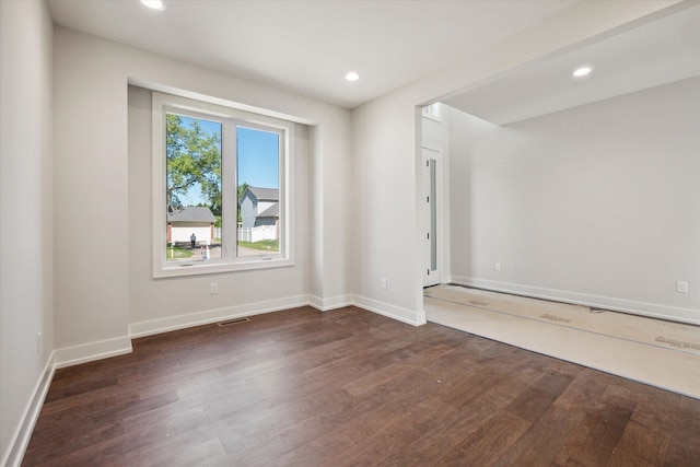 spare room featuring dark hardwood / wood-style flooring