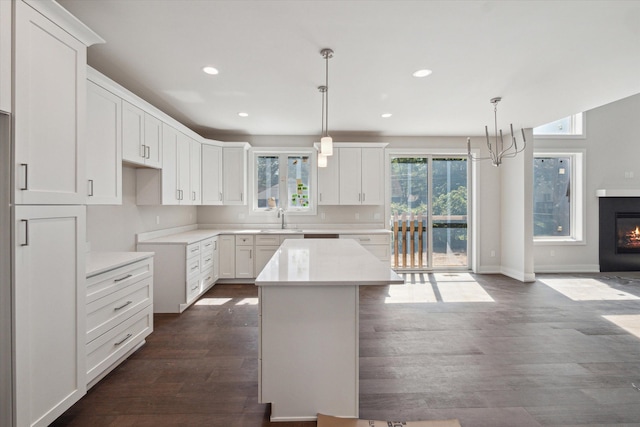 kitchen with white cabinetry, pendant lighting, and a center island