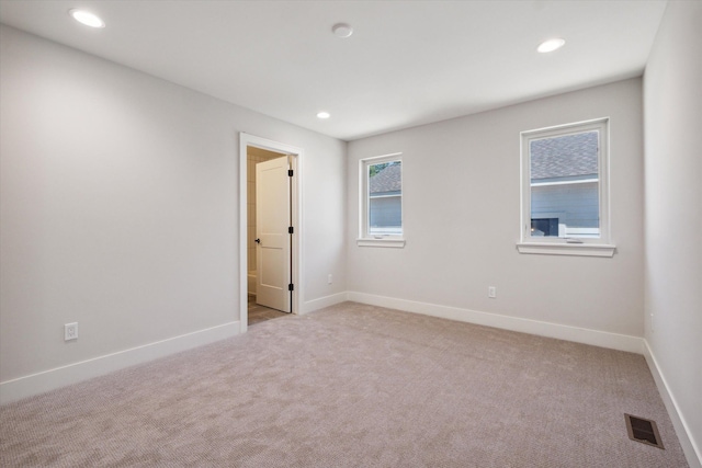 spare room with light carpet