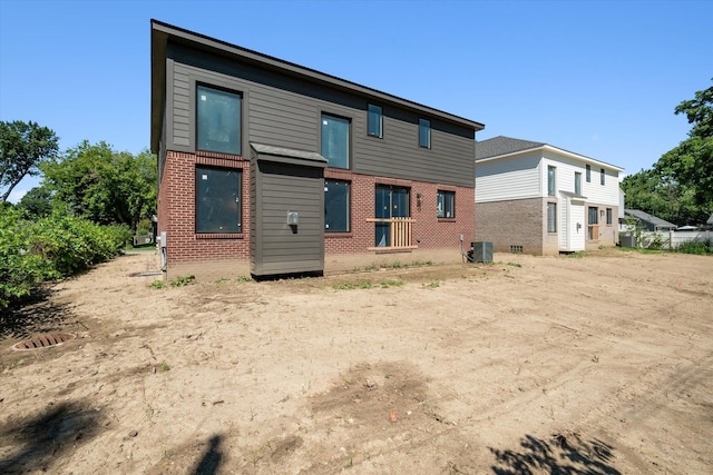 rear view of house featuring central AC unit