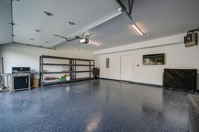 garage featuring electric panel, baseboards, and a garage door opener