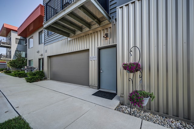 garage featuring concrete driveway