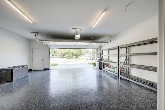 garage featuring a storage shed and a garage door opener