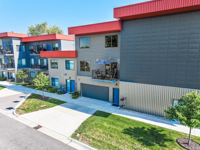 view of building exterior with an attached garage and driveway