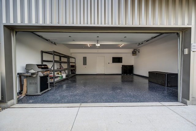 garage with electric panel and baseboards