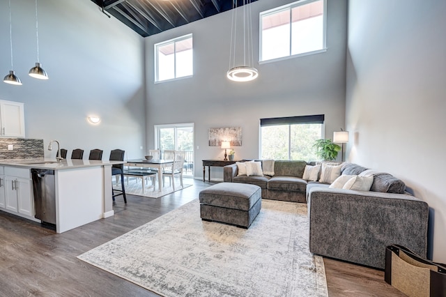 living room with beamed ceiling and dark wood-style flooring